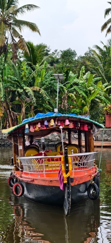 Decorated Kerala shikara boat with a colourful canopy on the backwaters