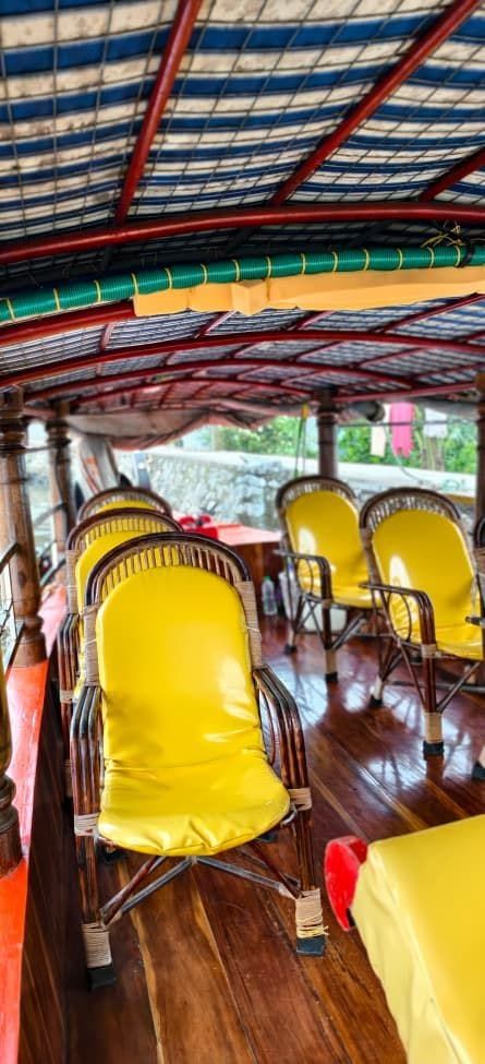 Cushioned chairs inside a covered shikara boat