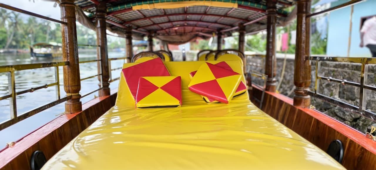 Lounge-style cushioned bed inside a shikara for a relaxed backwater ride