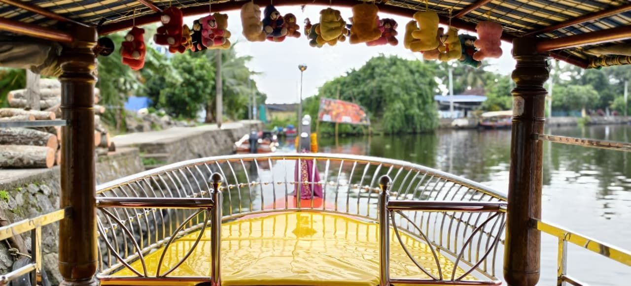 View of a narrow Alleppey canal from the deck of a shikara
